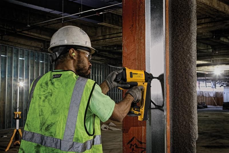 Trabalhador usa DEWALT, DGN845D1-QW e DGN845D1, em estrutura metálica na obra.
